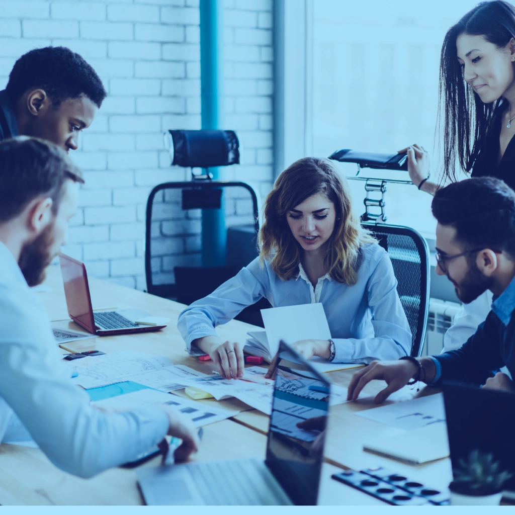 Diverse group of trade compliance professionals collaborating on a project